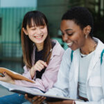 two female students in a school, getting school news in hong kong 2026