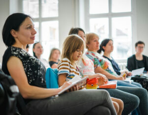 parents and students in a classroom learning about the school at an open day