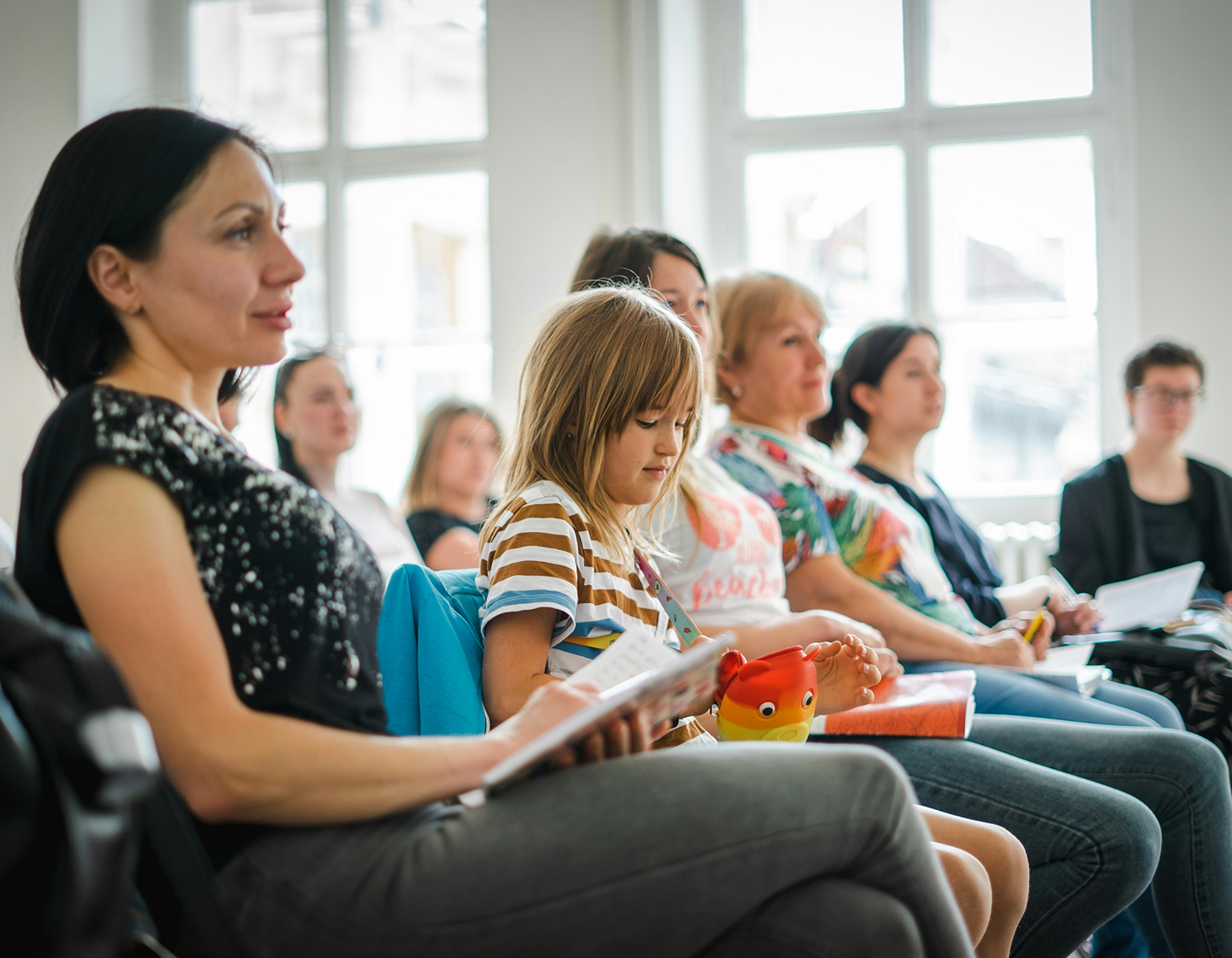 parents and students in a classroom learning about the school at an open day