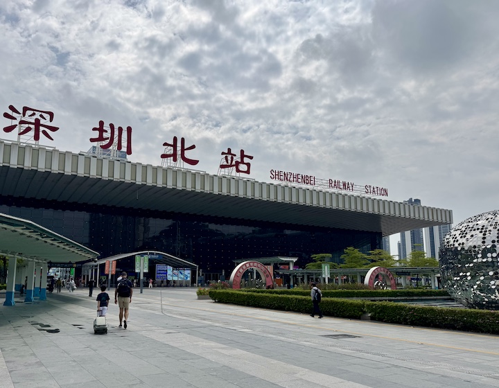 father and son cross the shenzhen Hong Kong border by train station