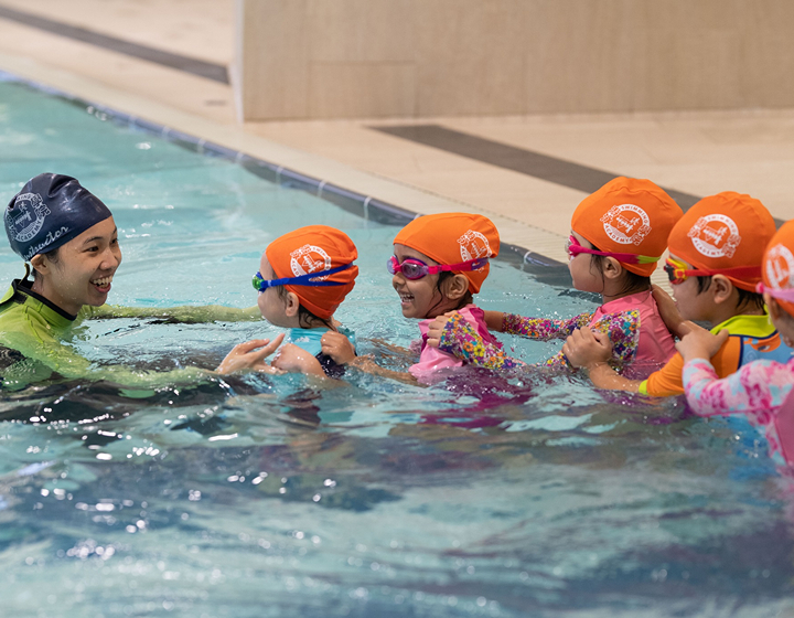 swimming coach leading a group of students in the pool, hong kong swimming class at YMCA