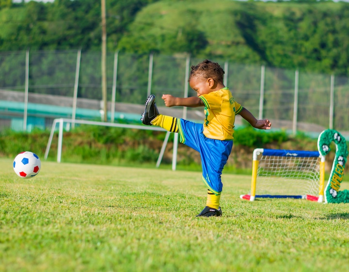 a toddler plays football