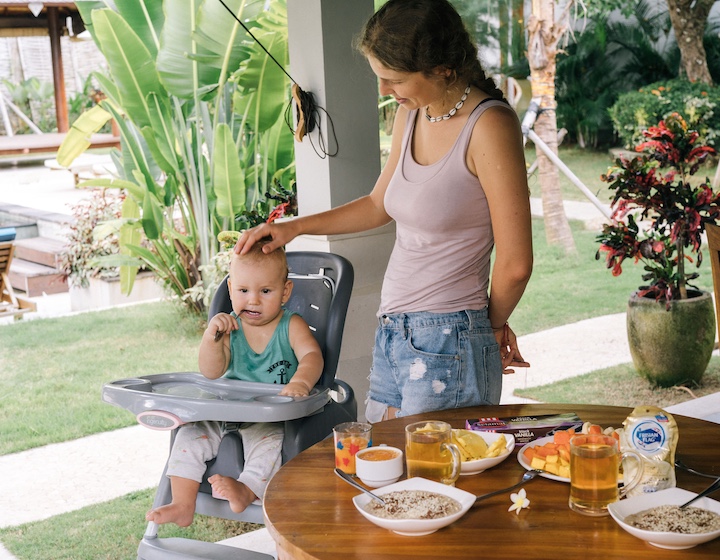 mum and baby feeding at the table while on holiday