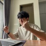 A Hong Kong student cheers when he receives his IB results