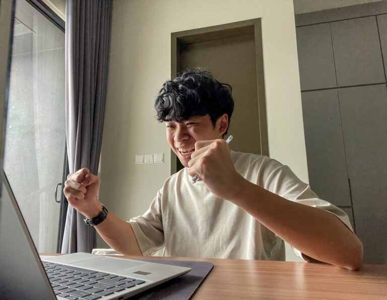 A Hong Kong student cheers when he receives his IB results