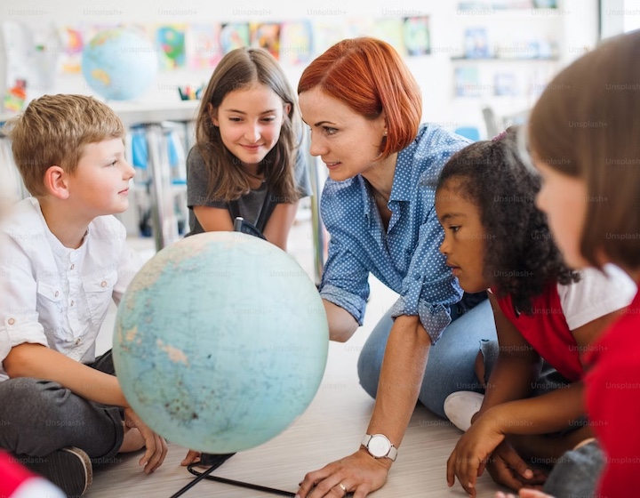 a teacher in a classroom at an affordable international school in Hong Kong