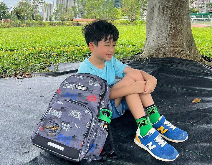 young student outside with a Millton backpack, ergonomic school bags for kids in Hong Kong