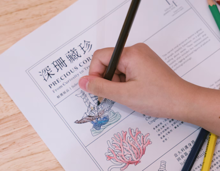a child's hand drawing coral to be used in jewellery making
