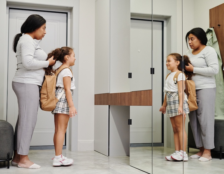 a mum and daughter getting ready for school after paying a debenture in Hong Kong