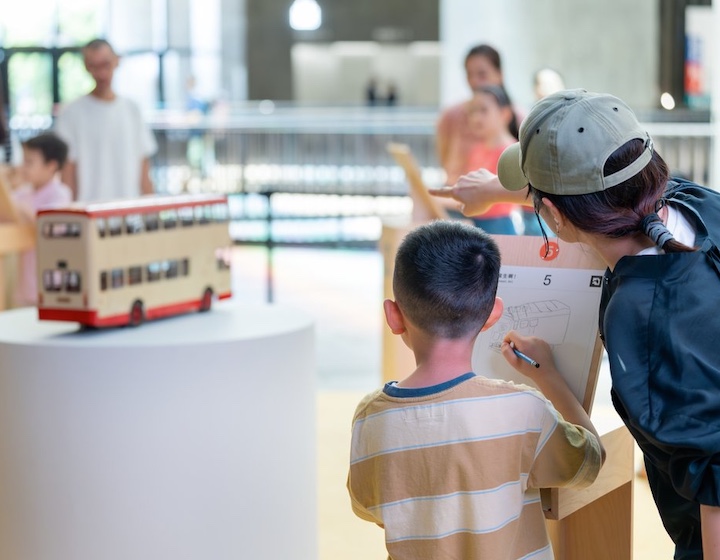 a child sketches a bus at an art workshop at M+ Hong Kong