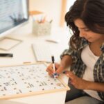 a woman writing the Hong Kong international school calendar 2026 and 2027