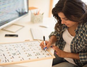 a woman writing the Hong Kong international school calendar 2026 and 2027