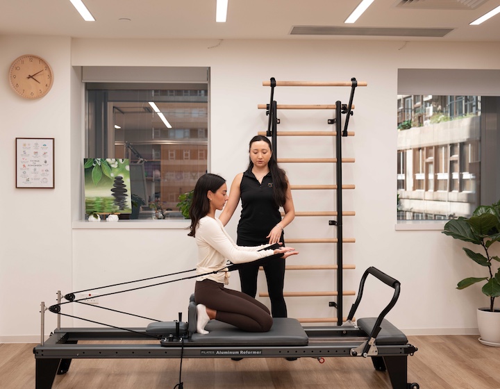 a pregnant woman does a private prenatal pilates class at Hong Kong Sports Clinic