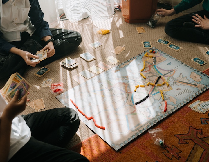 family playing board games as an easy indoor activity in Hong Kong on a rainy day