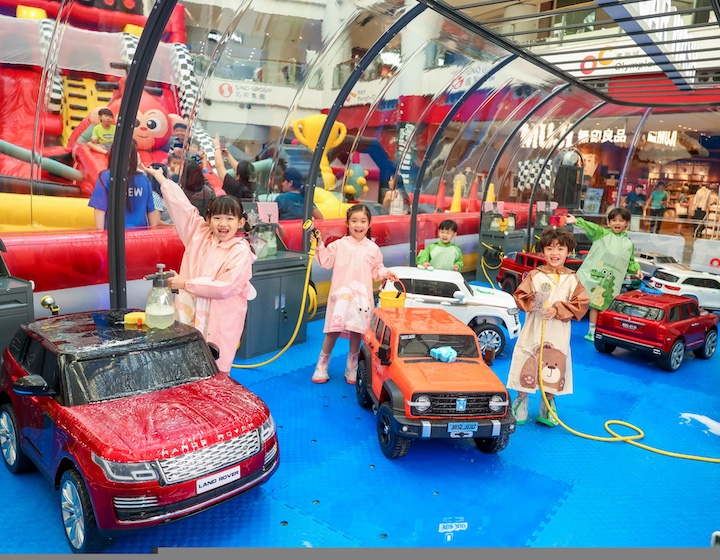 children pretending to wash a play car at Jumptopia activity in olympian city Hong Kong