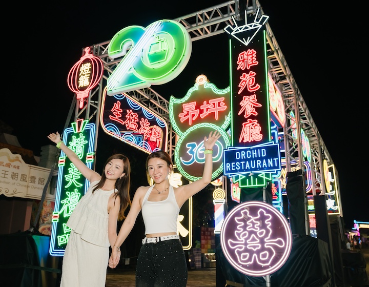gong-ping-night-neon two Hong Kong women enjoy the neon lights at ngong ping to celebrate the 20th anniversary