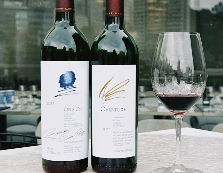 two bottles of wine and a wine glass from Kings Wine Cellar in Hong Kong, a physical and online wine retailer with thousands of bottles for sale