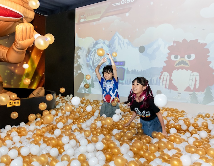 two children playing in a ballpit at the ultra man heroes exhibition in Mong Kok