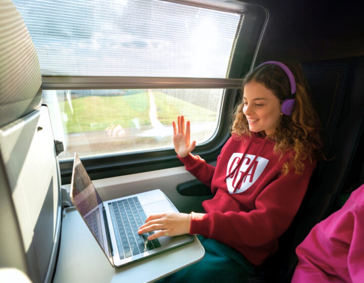 a student at crimson global academy studies online from a train