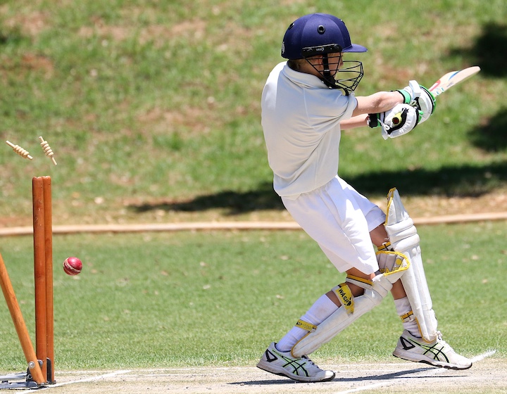a teenage boy plays cricket in Hong Kong