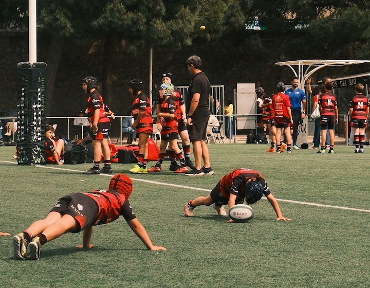 a junior Hong Kong rugby team trains on an outdoor grass field