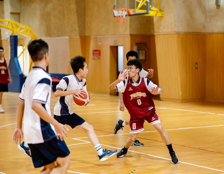 Hong Kong teenagers play basketball indoors