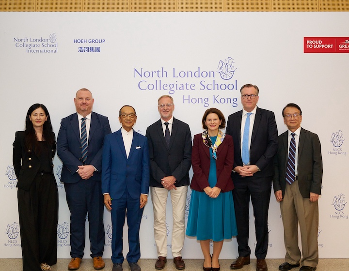 the leadership team of north London collegiate school (NLCS) gather in front of a sign at the press event to announce the launch of nlcs in Hong Kong