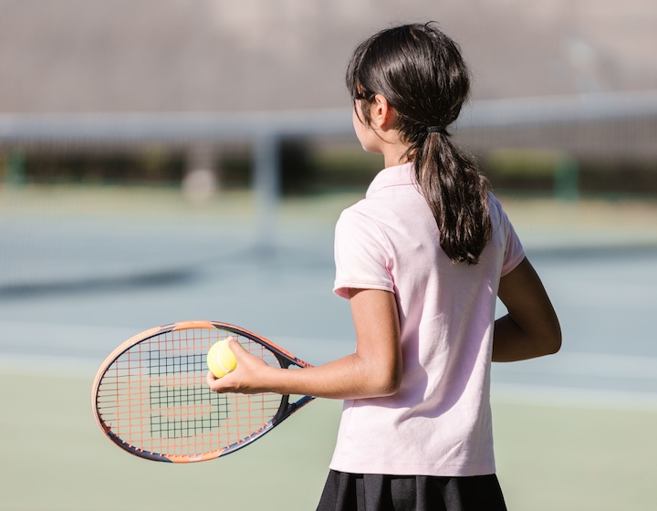 a girl takes tennis lessons in Hong Kong