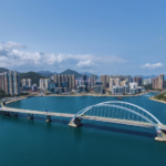 aerial view of the cross bay bridge and tseung kwan o in the background