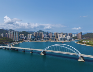 aerial view of the cross bay bridge and tseung kwan o in the background