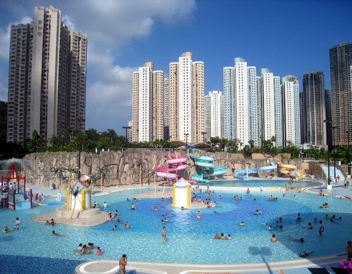 families swim and play on water slides at TKO swimming pool 