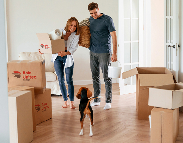 Couple and dog packing up their house to move with Asia United Group relocation company