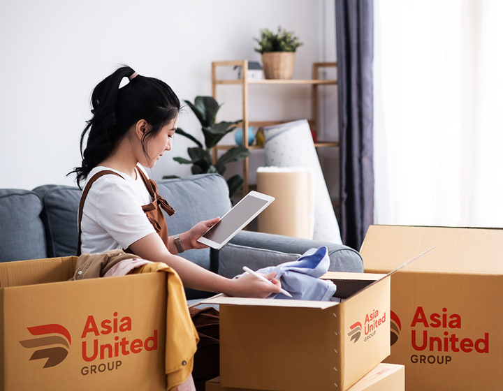 woman packing up her house for a move with Asia United Group relocation company