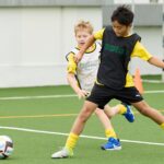two students play football at bvb academy at German Swiss international School Hong Kong