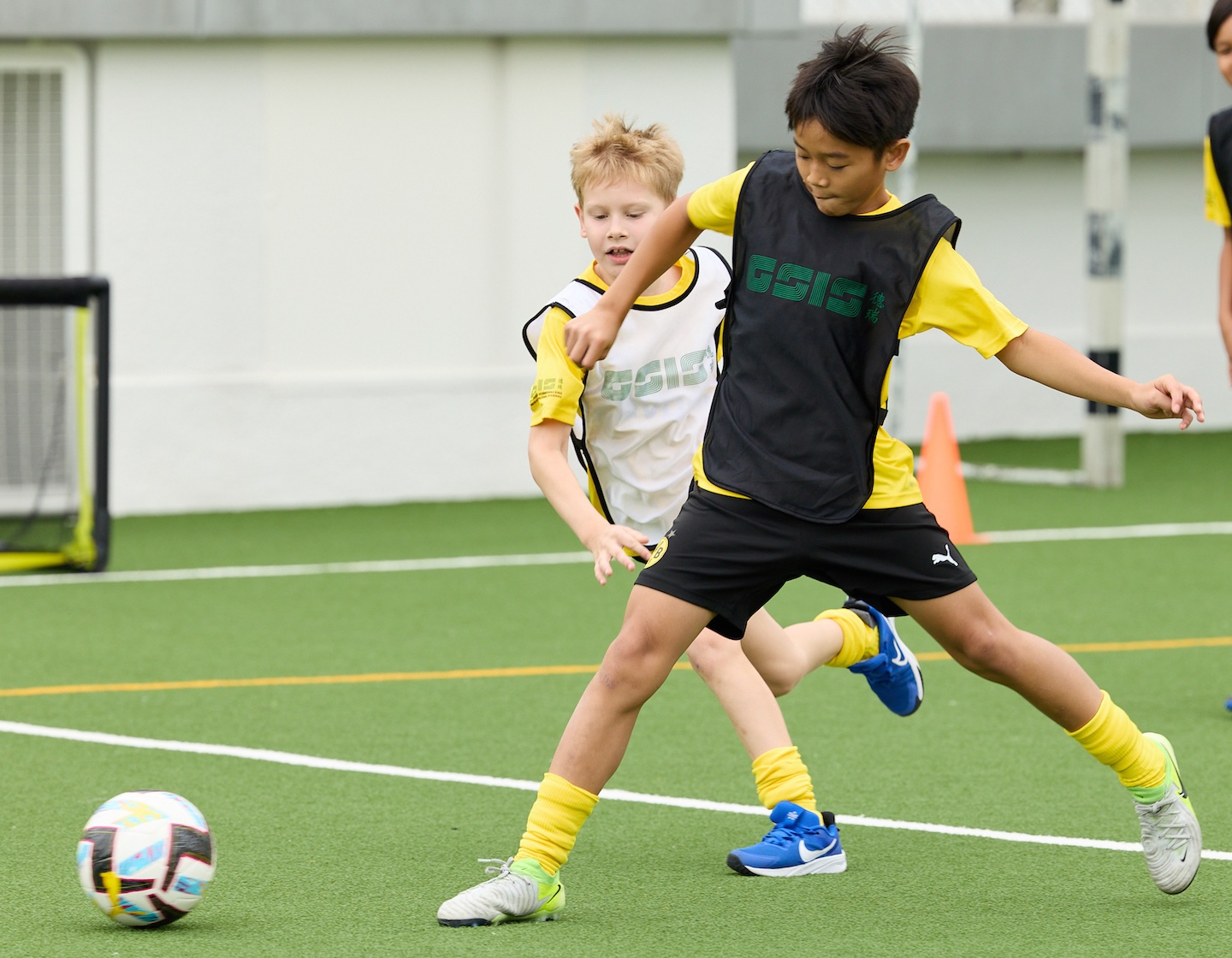 two students play football at bvb academy at German Swiss international School Hong Kong