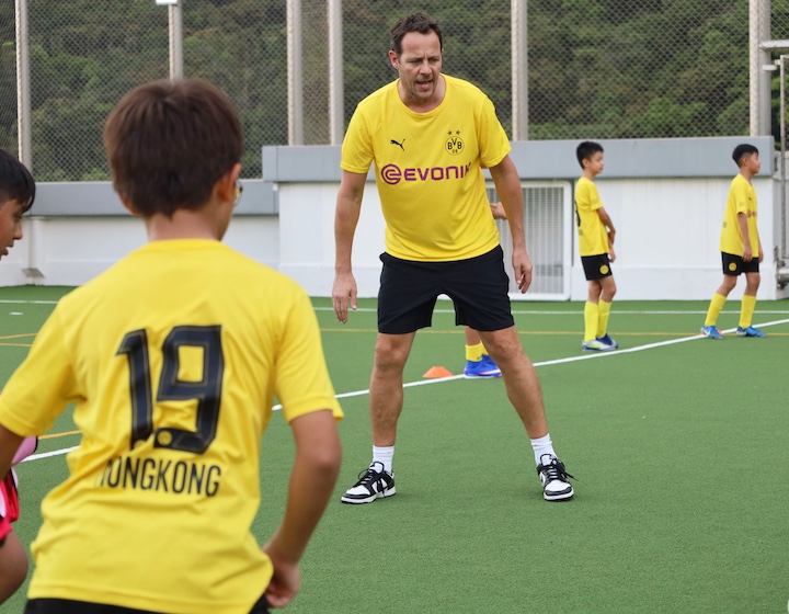 a coach teaches football classes at bvb academy at GSIS Hong Kong