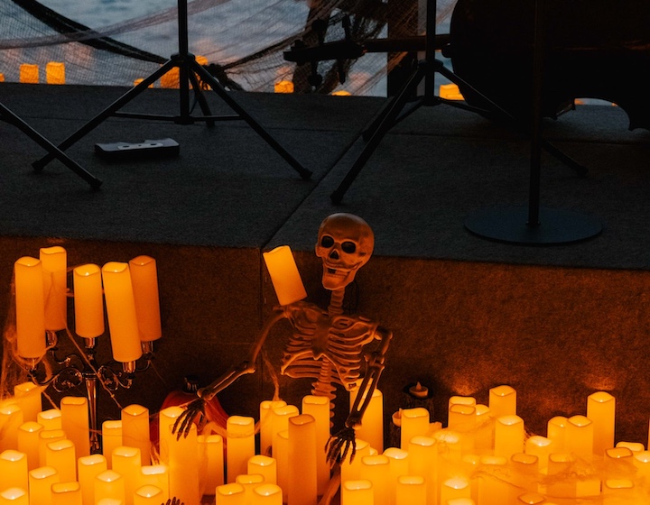 glowing candles set up in front of a skeleton for a halloween concert event at the Hong Kong Maritime museum