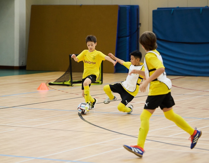 children learn expert football skills indoors at gsis 