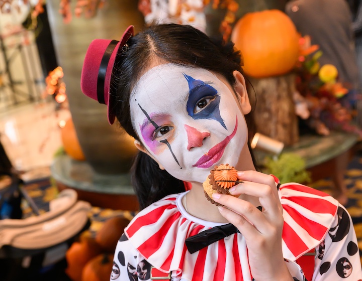 a girl dressed up as a spooky clown for halloween at the island shangri-La la best dressed competition