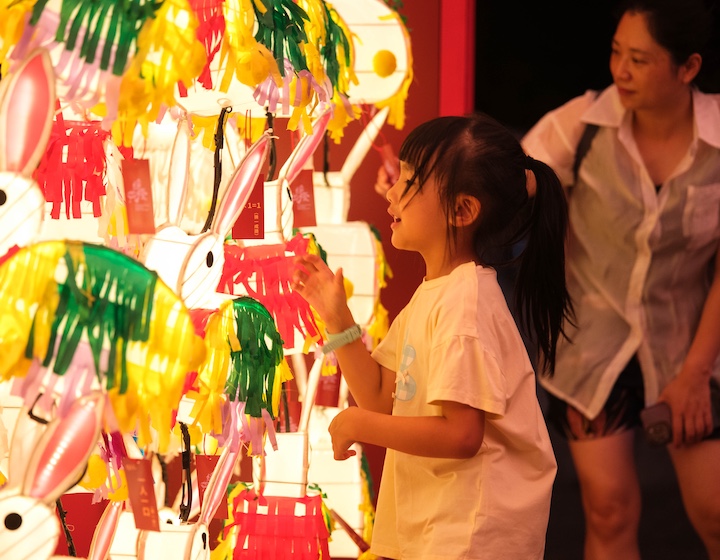 a girl looks at rabbit lanterns with her mum at the international lantern festival in Victoria Park Hong Kong during Mid Autumn Festival 2026