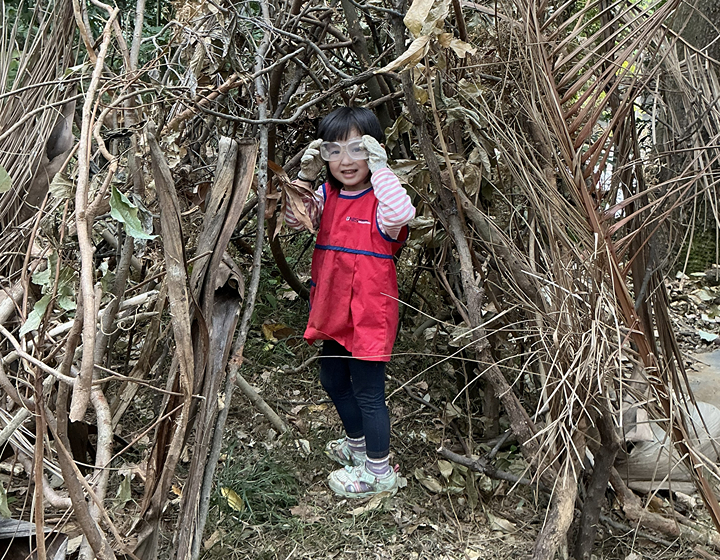 students amongst bare trees in a forest near Norwegian International School in HK