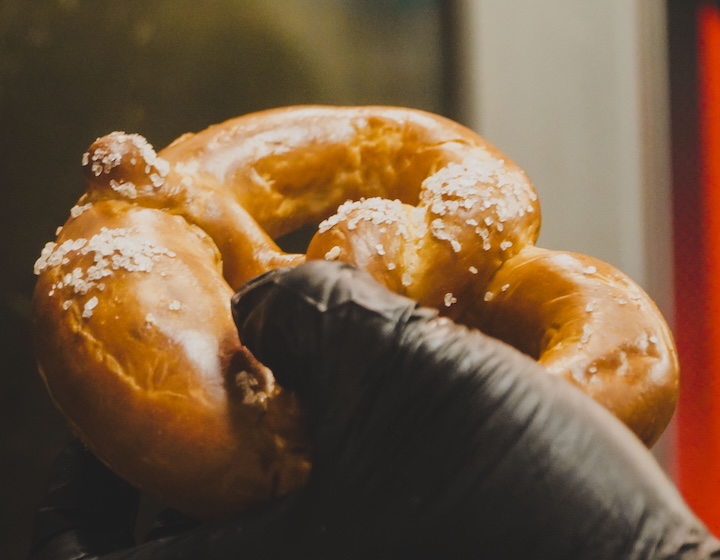 Hand holding a pretzel at the Frites family Octoberfest celebrations in Hong Kong