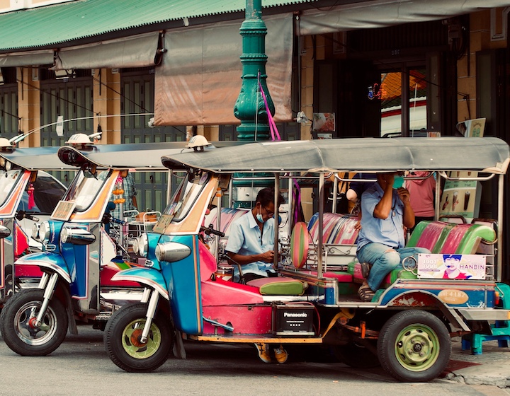 tuk tuks lined up on the street in old town Phuket