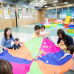 kids and parents playing parachute game at Little Habs playgroup in Tai Kok Tsui, Kowloon, Hong Kong playgroup for kids