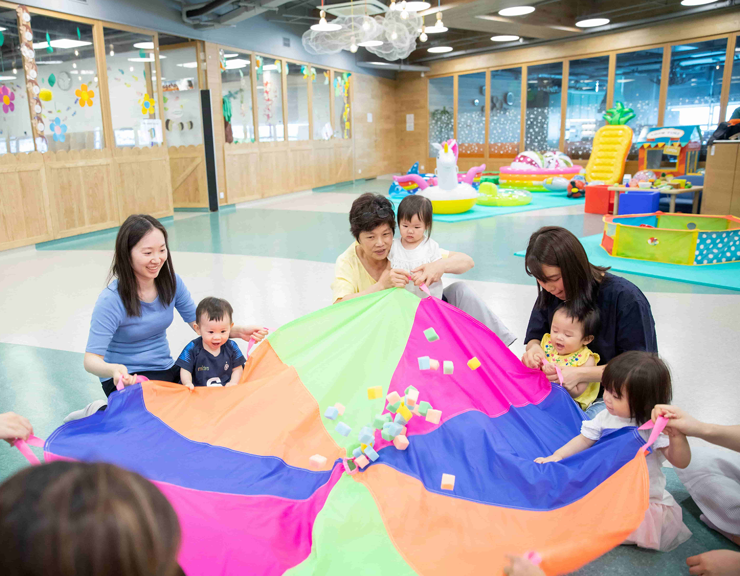 kids and parents playing parachute game at Little Habs playgroup in Tai Kok Tsui, Kowloon, Hong Kong playgroup for kids
