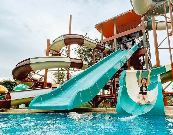 a woman slides down a waterslide at thavorn palm beach resort phuket