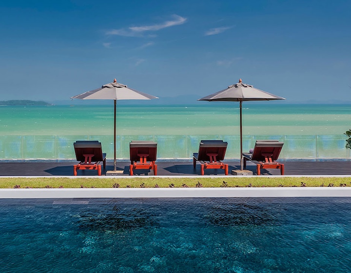 sun loungers facing the ocean in front of the infinity pool at 10 bedroom phuket villa sawarin in cape yamu