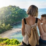 a mother and son look at the beach and ocean from their private family villa in phuket
