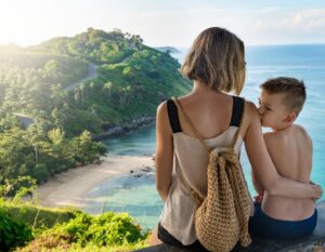 a mother and son look at the beach and ocean from their private family villa in phuket