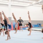 a group of gymnasts practising handstands